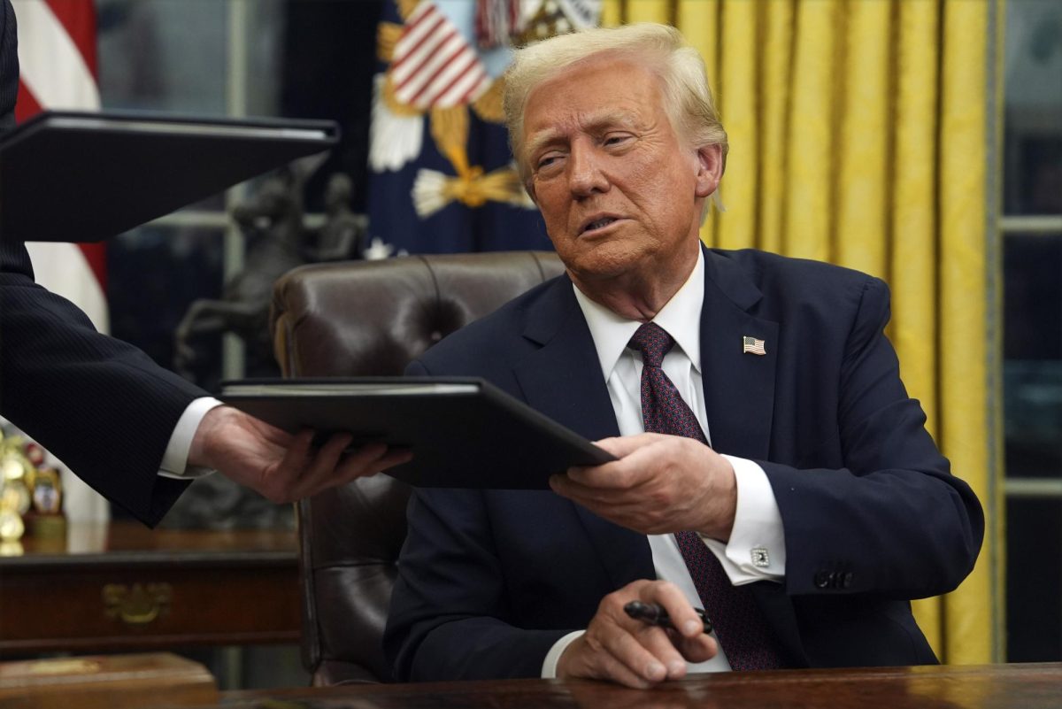 President Donald Trump signs executive orders in the Oval Office of the White House, Jan. 20, 2025, in Washington.