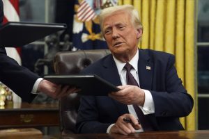President Donald Trump signs executive orders in the Oval Office of the White House, Jan. 20, 2025, in Washington. 
