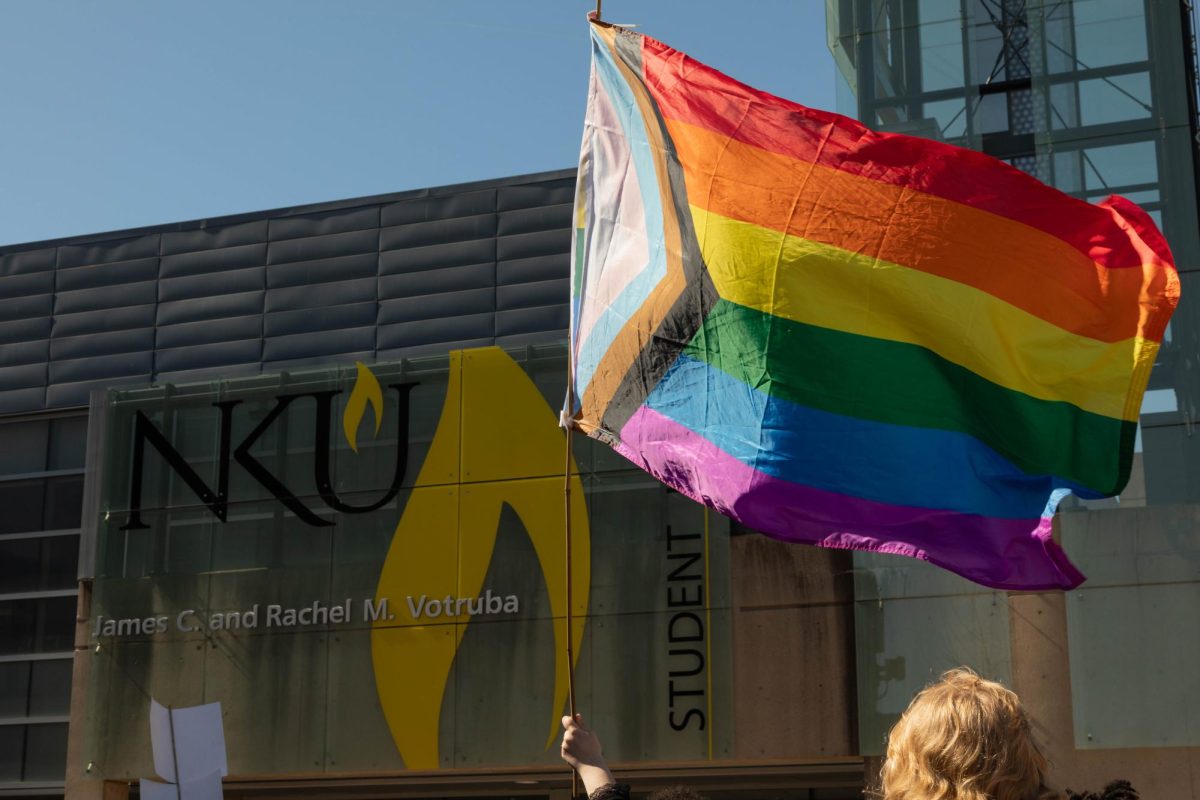 An LGBTQ+ flag waving in front of of the Student Union on NKU's campus.