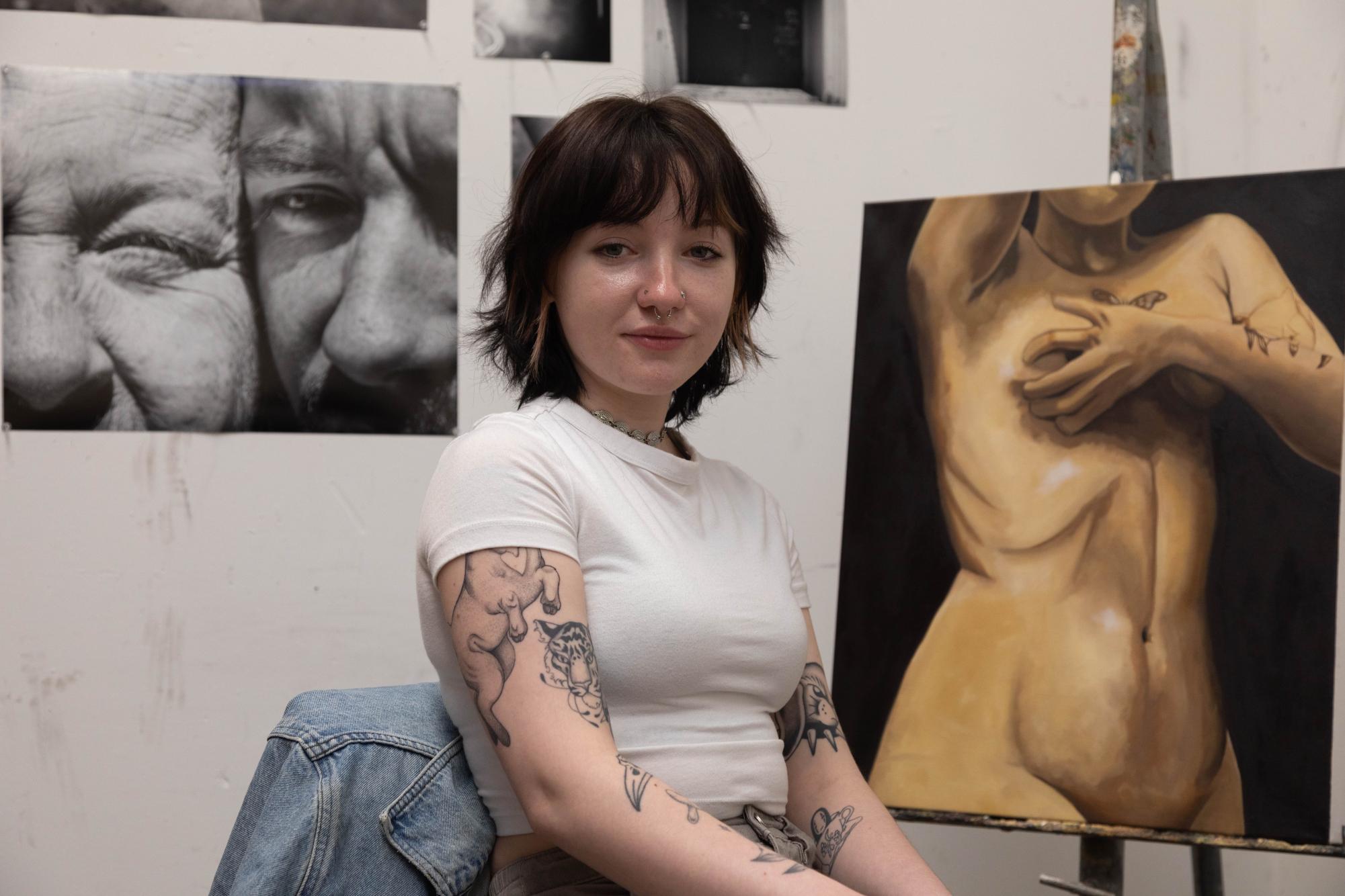 Hez Sumner sits in their personal studio space.
