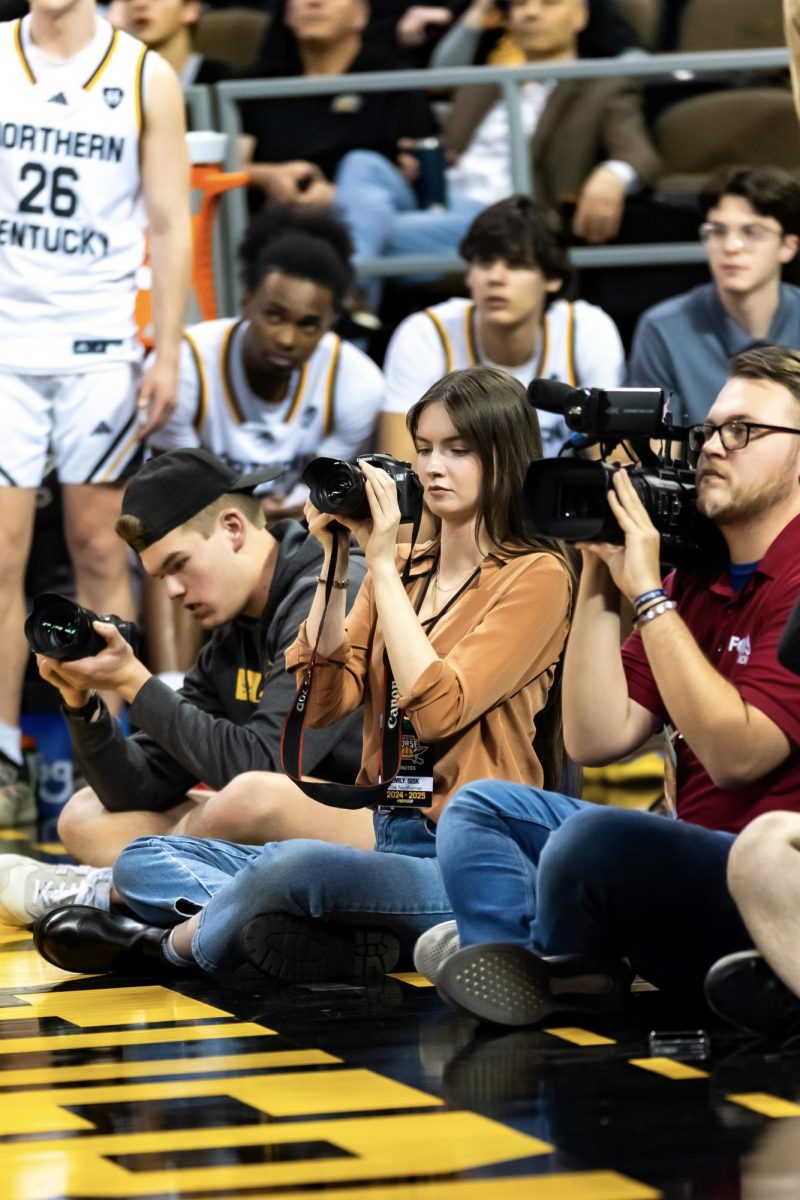 Emily Sisk records video at a men’s basketball game.