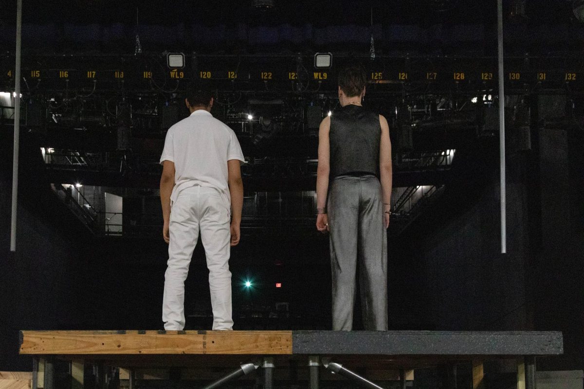 NKU actors Isaiah Burton (left) and Bodie Moore (right) stand on the stage platform facing their audience.