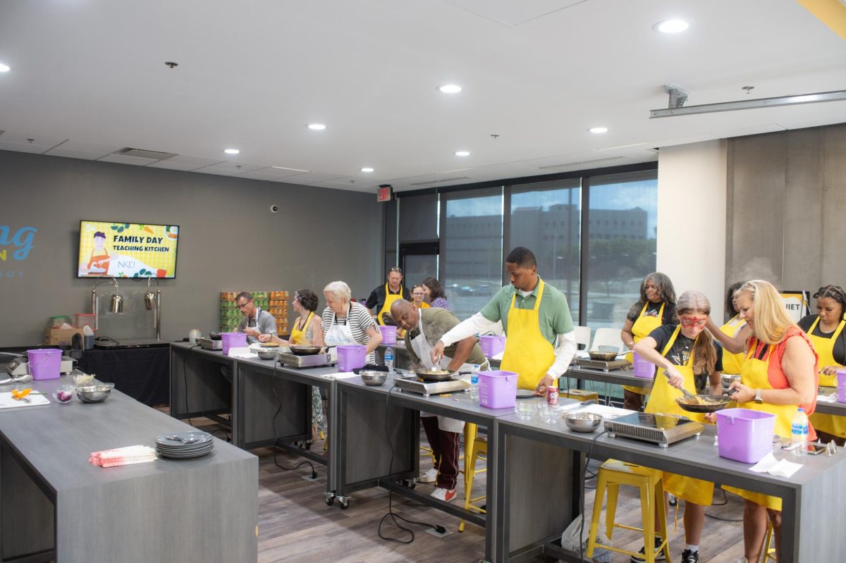 Students and parents participating in a teaching kitchen event at family day 2024. 