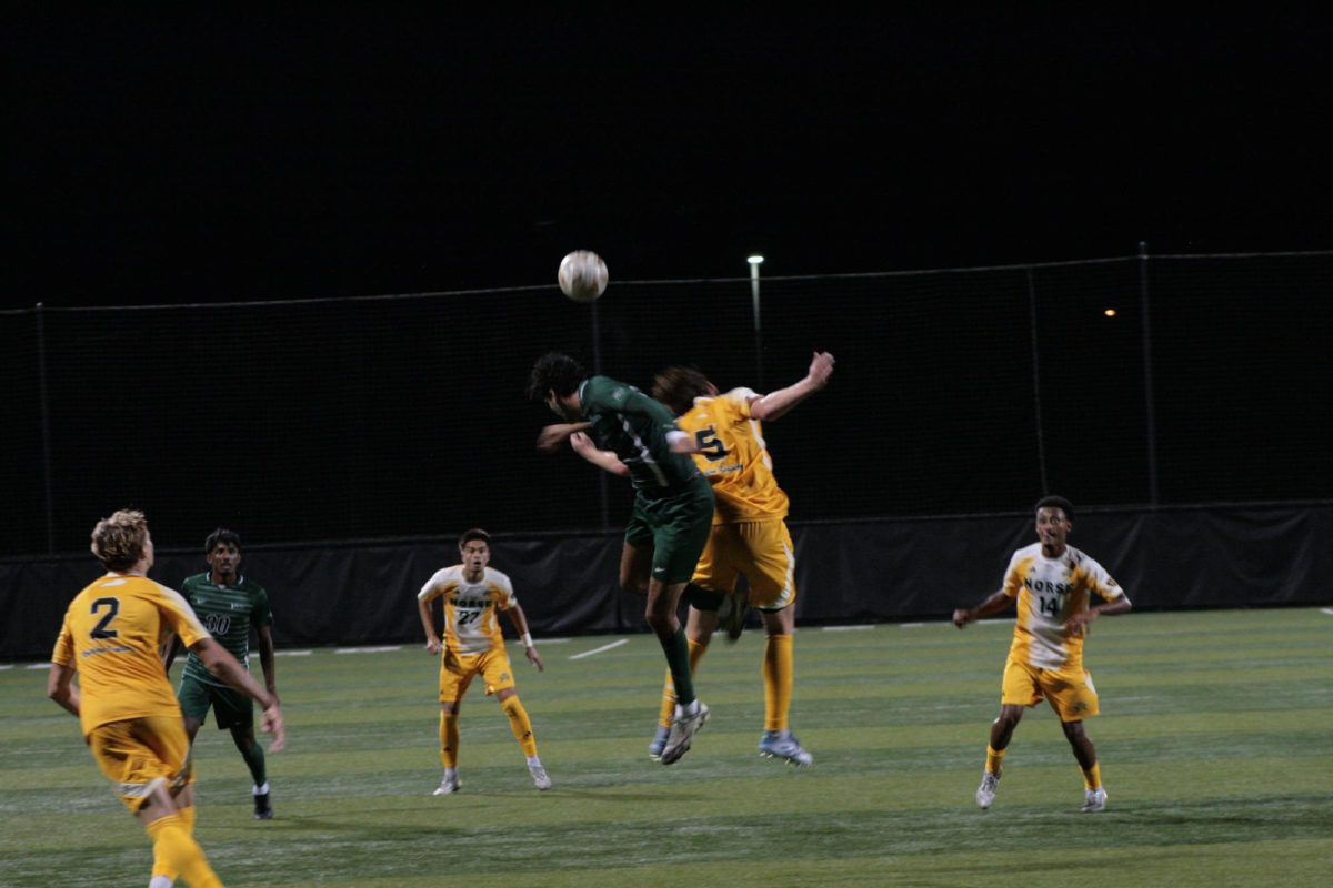 NKU midfielder Maddox Behnfeldt (5) going for the ball against a Green Bay player. The Norse fought hard against Green Bay. 
