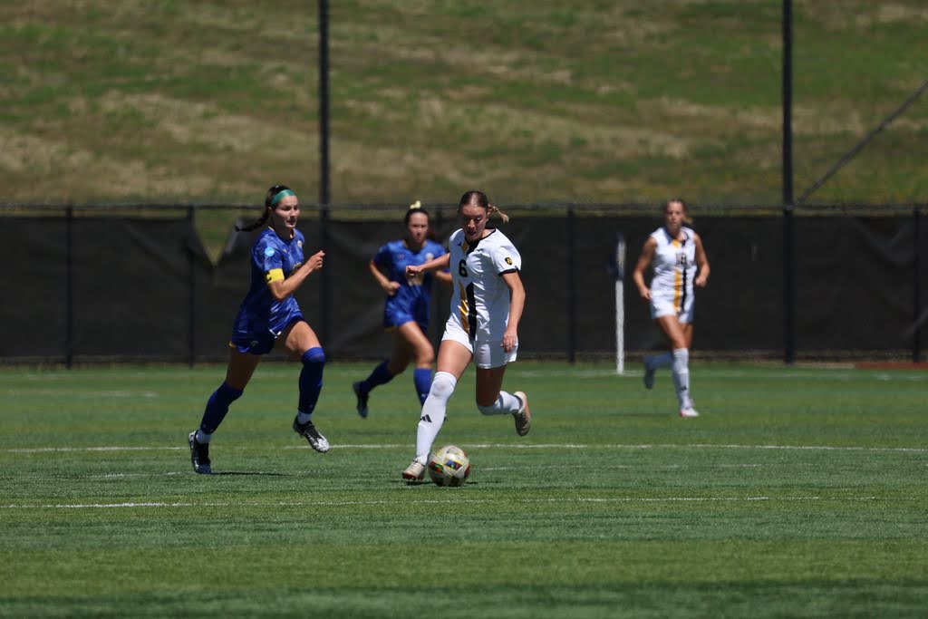 Graduate Student, Lily Yordy (6) dribbling across midfield. She recorded two goals and one assist.