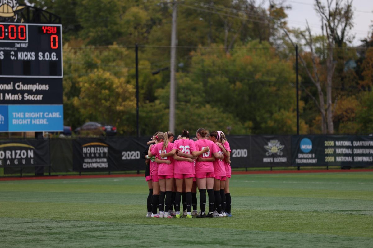 Women’s soccer huddling up before the game against Youngstown State. The women wore pink for Breast Cancer Awareness and got the 3-2 victory.