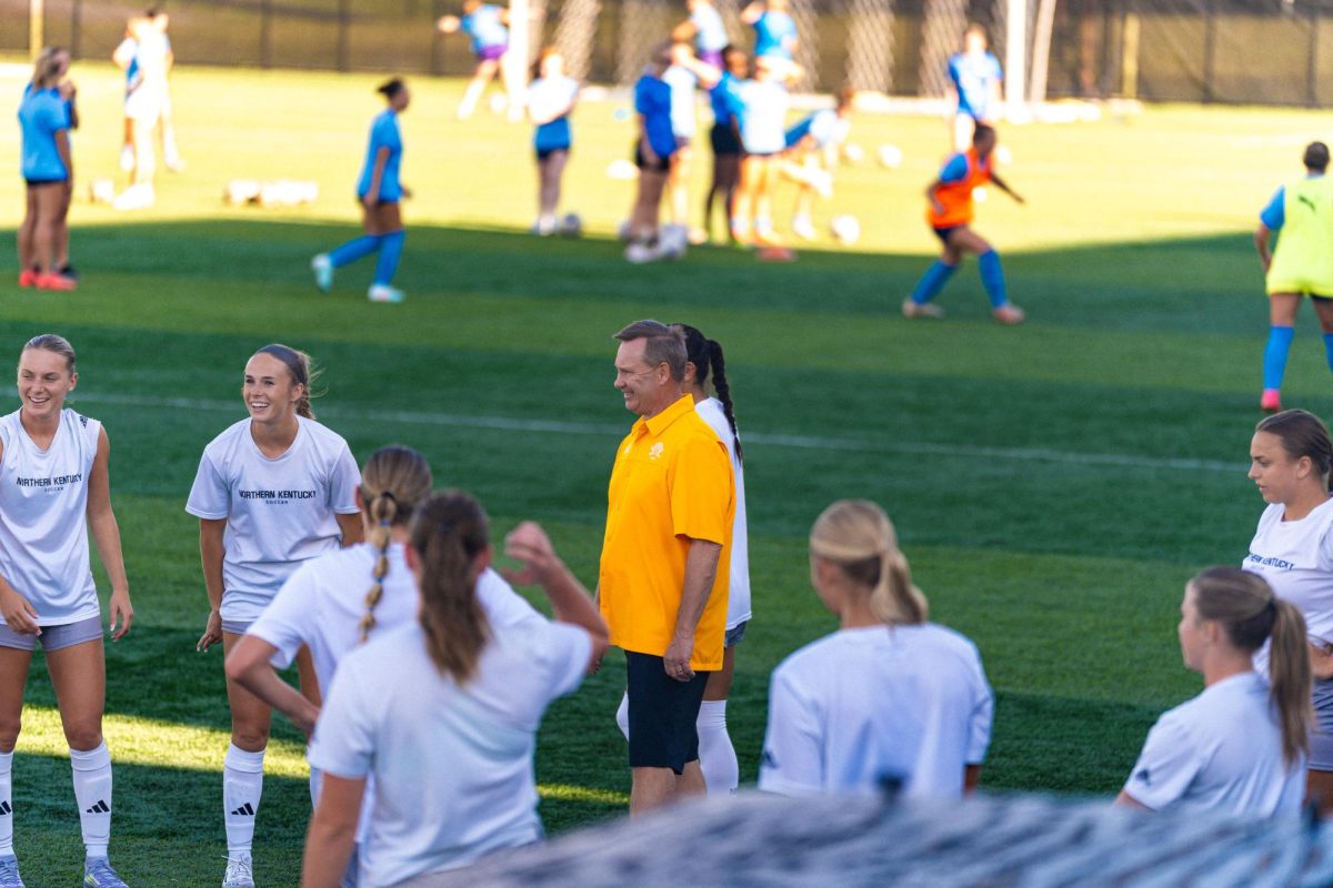 Bob Sheehan watching his team warm up before a game.