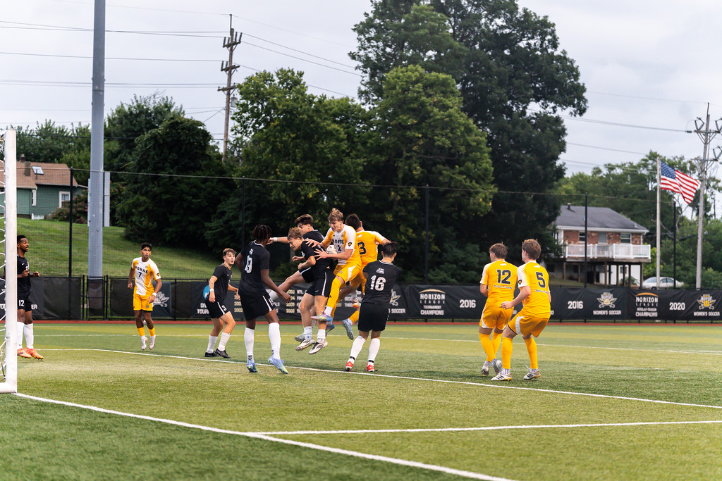 NKU men’s soccer players converging in an attempt to score a corner kick goal. 