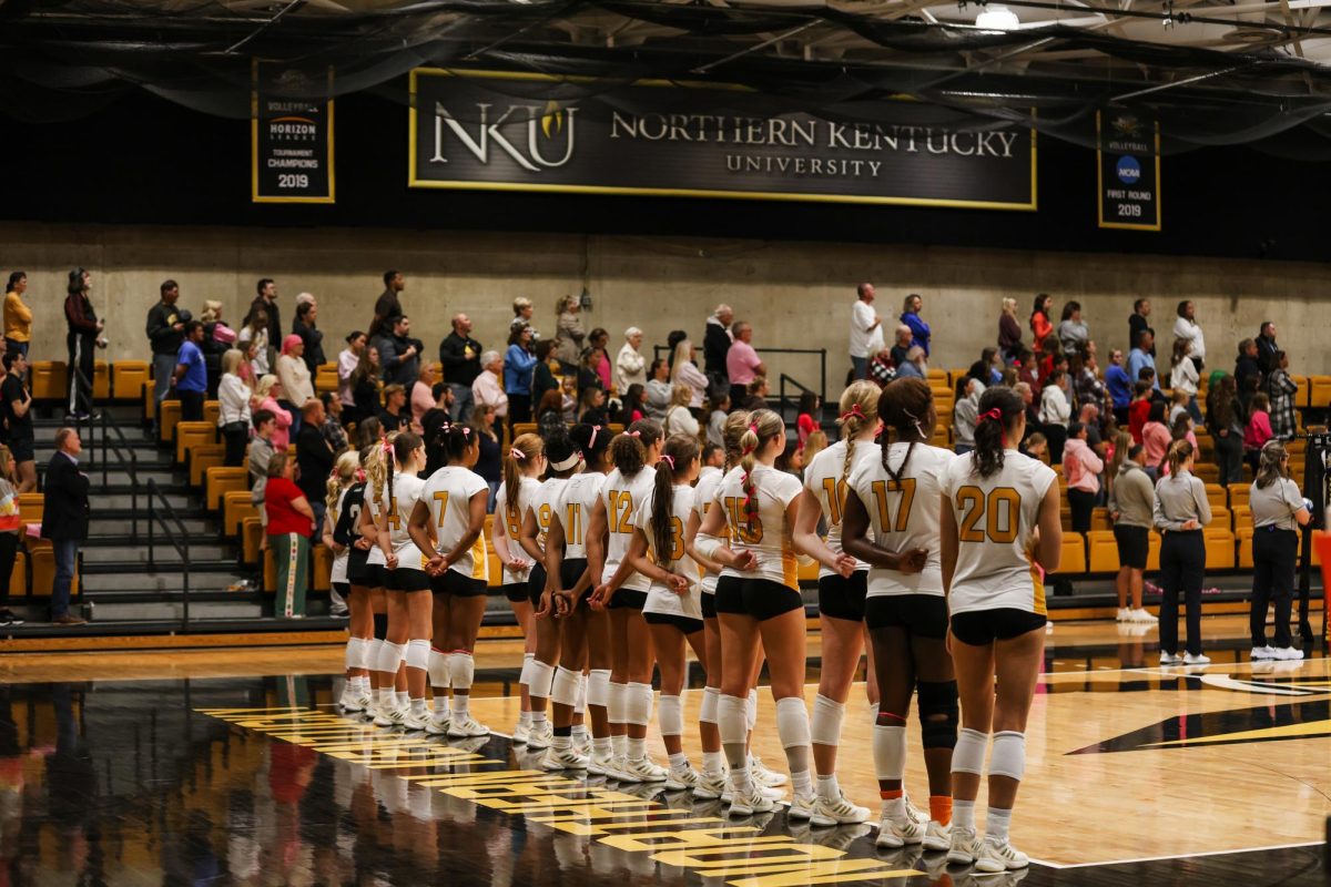 NKU women's volleyball standing for the flag before the game. The women got a huge 3-0 win on Breast Cancer Awareness night.