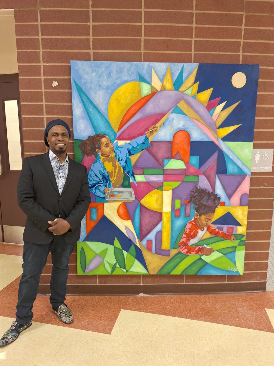 Cedric Cox stands in front of one of his paintings.