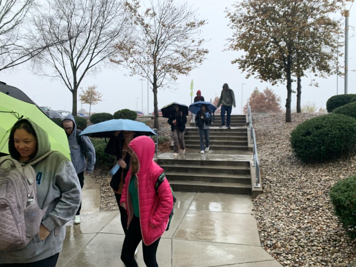 Students rushing back to Griffin Hall after a fire alarm evacuated them into heavy rainfall. 
