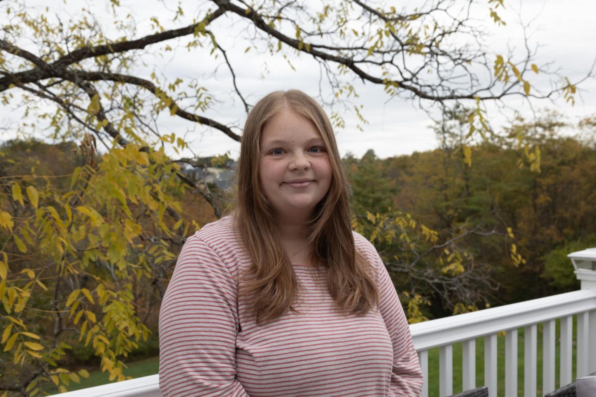 Molly Smallwood stands on the porch of her Alexandria home. Smallwood had her position eliminated at NKU on October 6, 2025. 