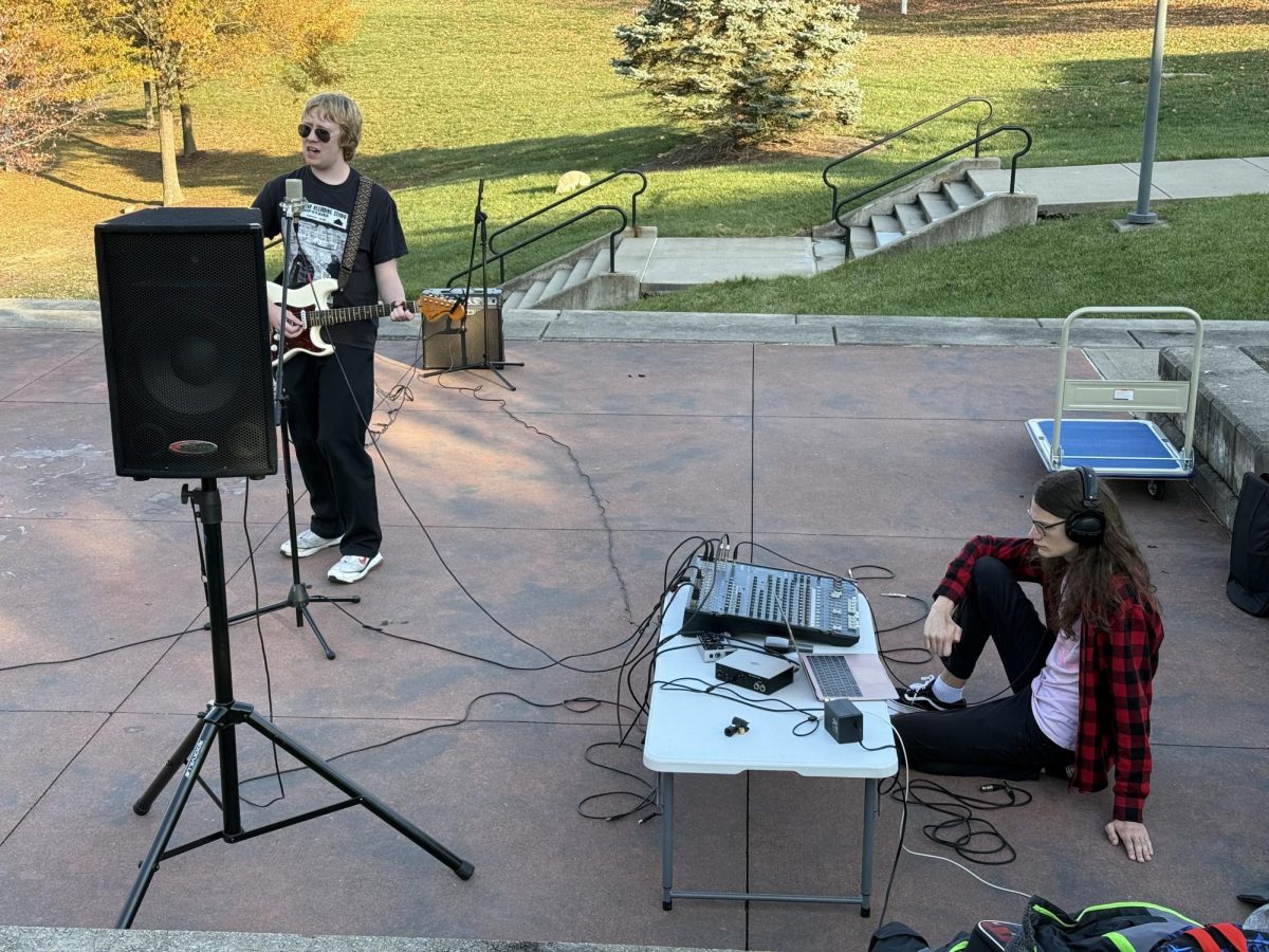 Noah Wheelock plays a solo set at Live at the Loch Friday, Nov. 14, as Norse Code Radio General Manager Joseph Gallucci runs the sound board.