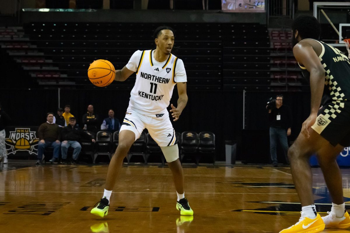 Graduate Student Tae Dozier (11) scanning the defense, looking to score. He recorded four double-digit point outings in each of his last five games.