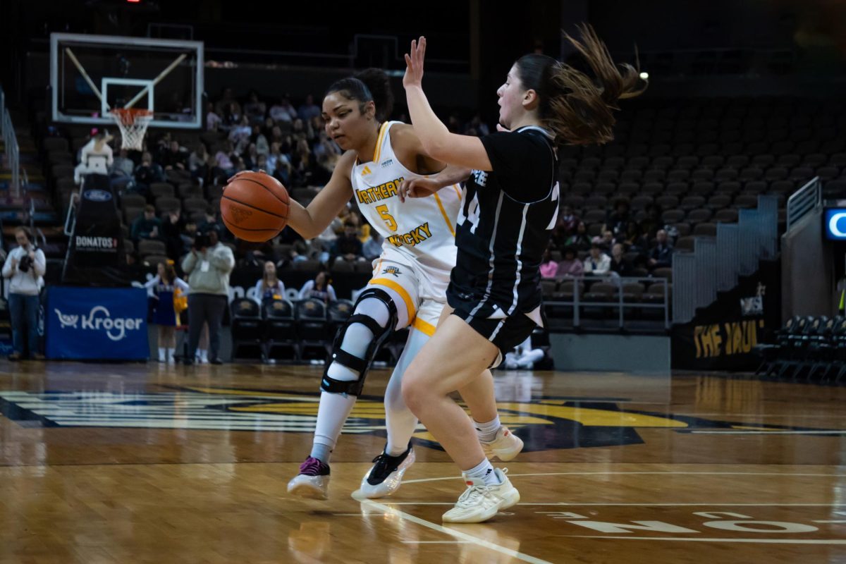 Fifth-year senior Mya Meredith (5) driving through contact. Meredith boasts 1030 career points from her time with Northern Kentucky University and Western Kentucky University.
