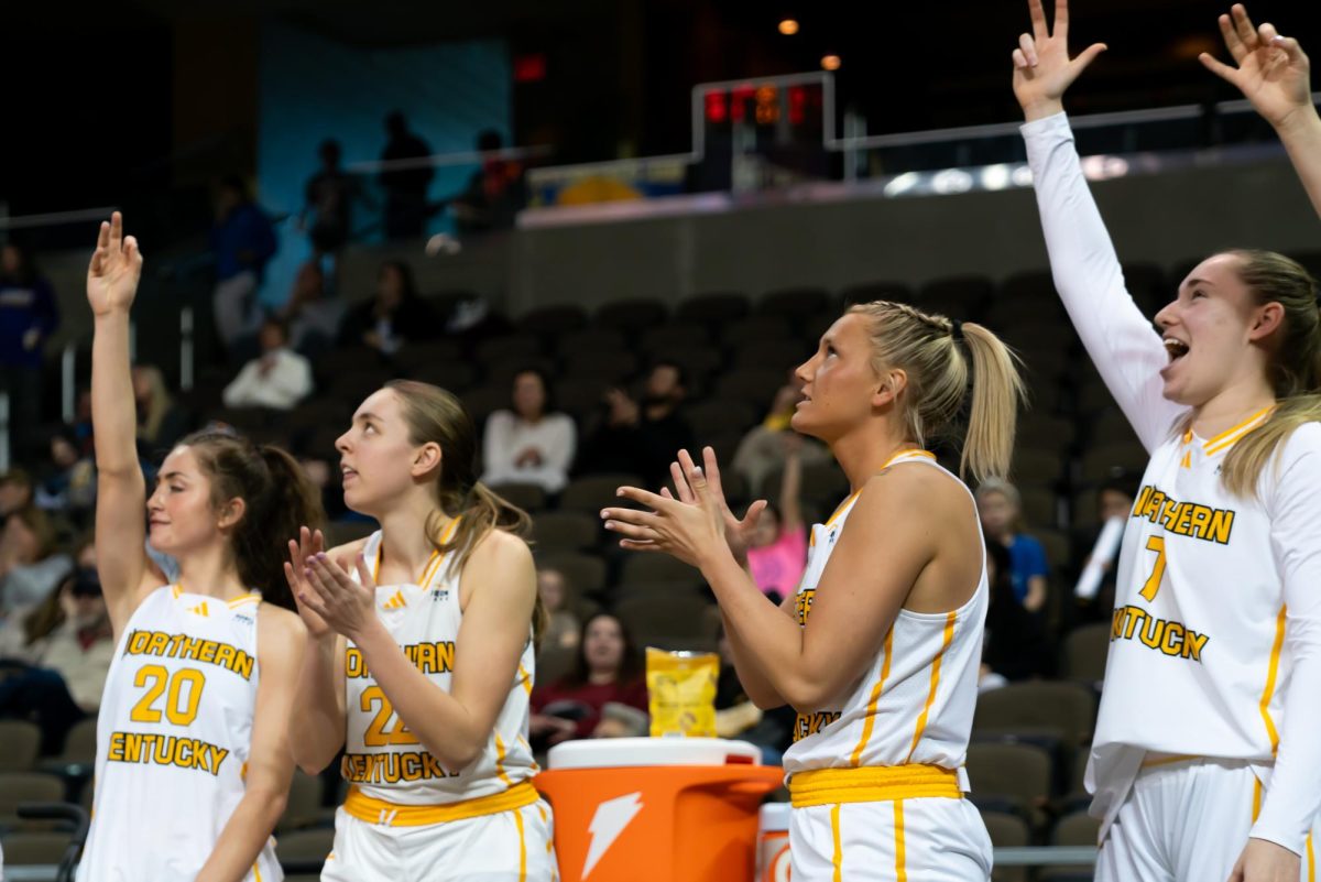 Karina Bystry (left), Noelle Hubert (left middle), Caroline Eaglin (right middle) and Alma Rashelbach (right) all celebrate a made basket on the bench. The Norse had 30 points off the bench against Detroit Mercy.