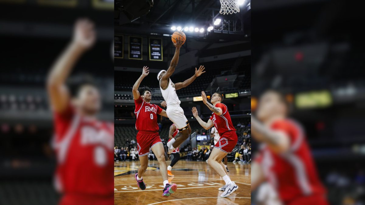 Donovan Oday (8) finishing at the rim between Robert Morris’s DeSean Goode (0) and Nikolaos Chitikoudis (16). Oday posted a career high 38 points.