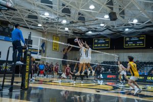 (Junior Griffin Wheatley (17) and sophomore Adam Blair (6) rising above the net for a block. They both recorded 10 kills.