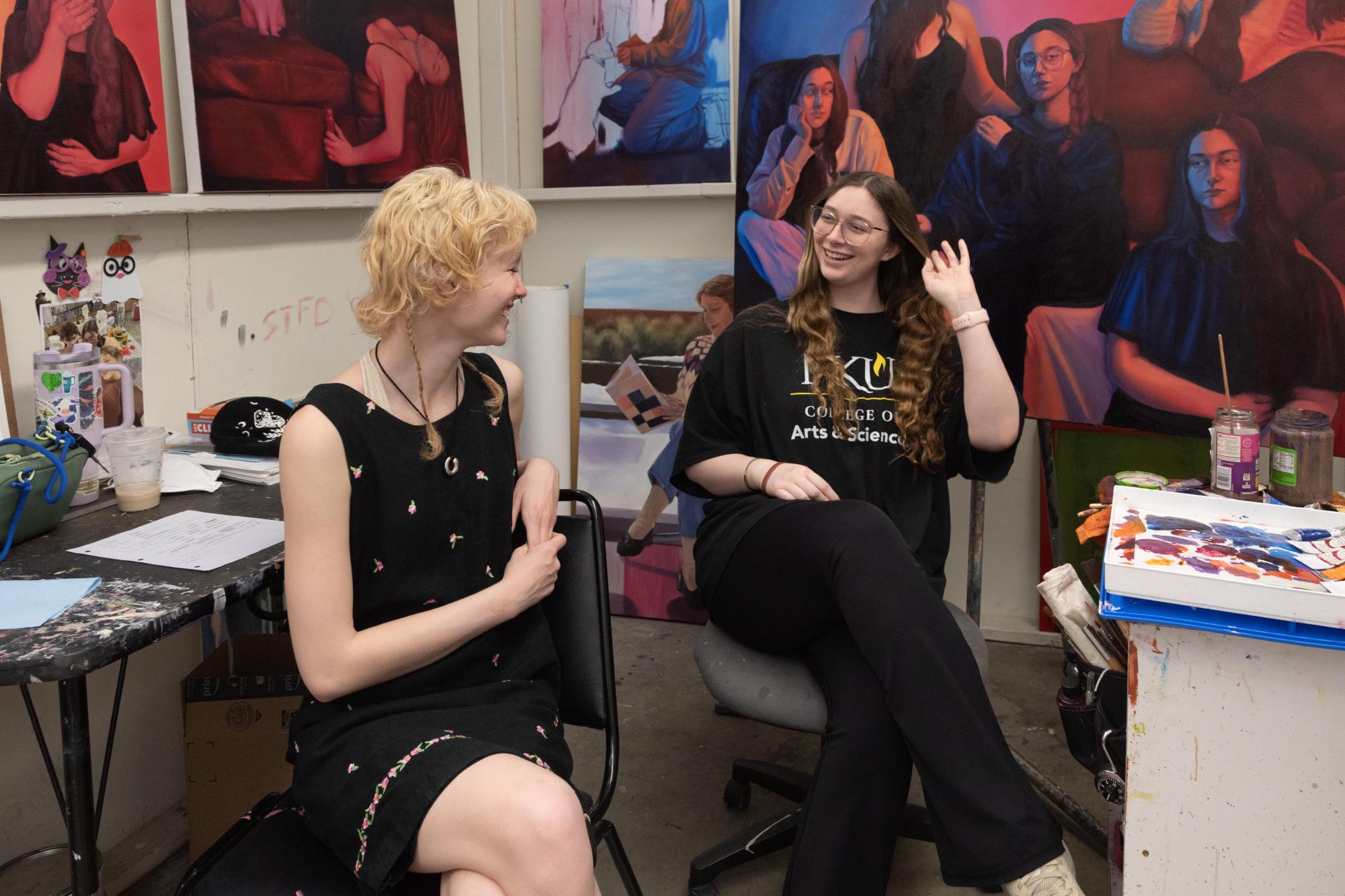 Bri Wallace (left) and Sarah Roszell (right) sit together in the BFA studio. 
